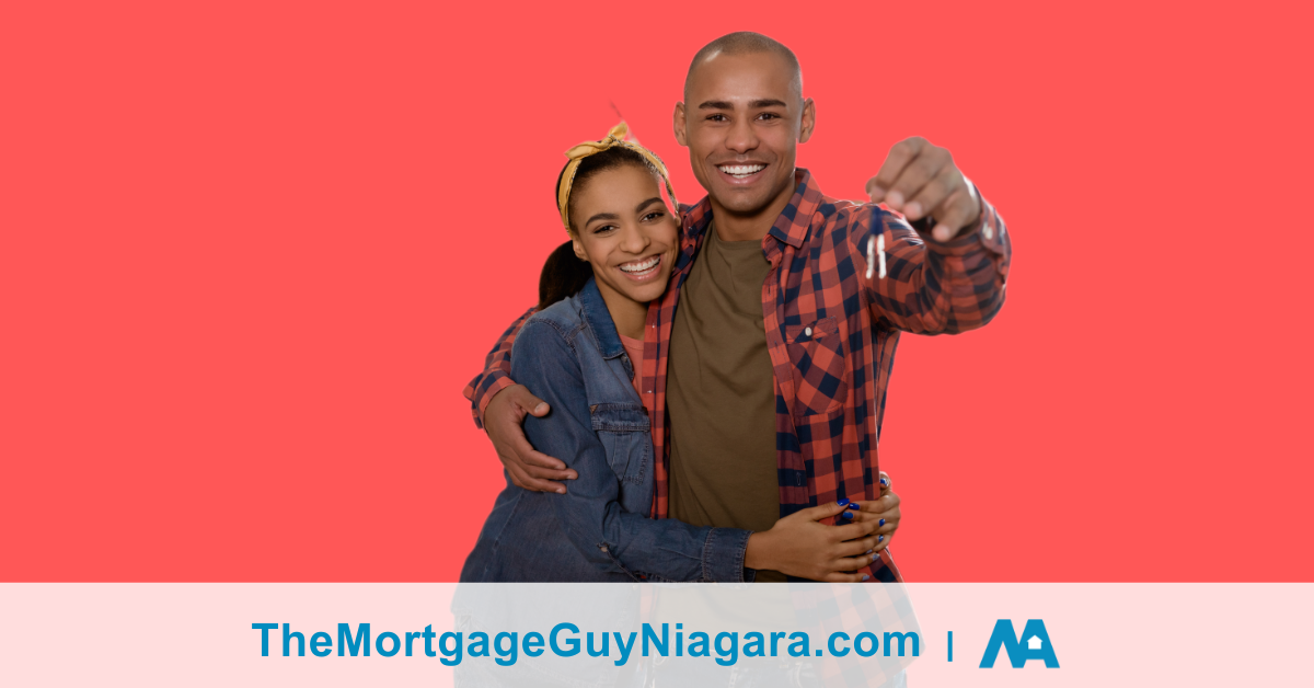 happy couple holding a set of keys to a house with a red background after meeting with a private mortgage lender also known as alternative lenders.